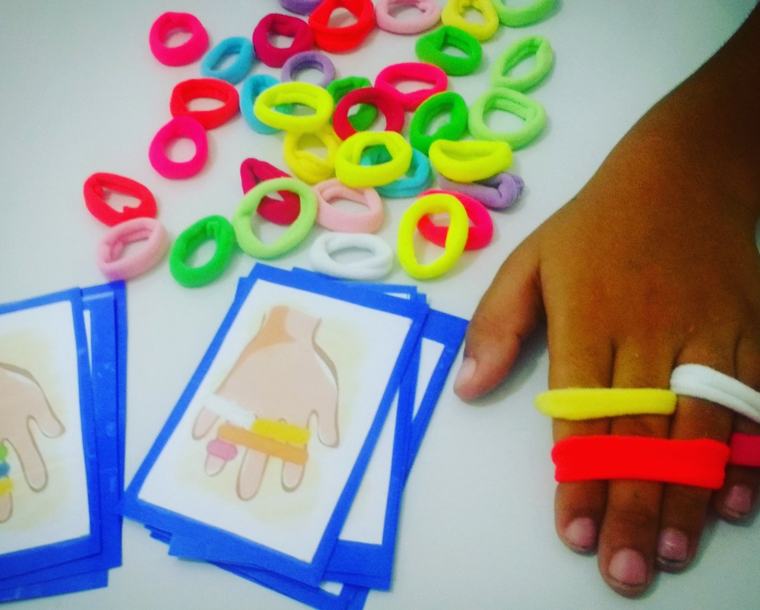 Cartas com mãos e elásticos coloridos nos dedos